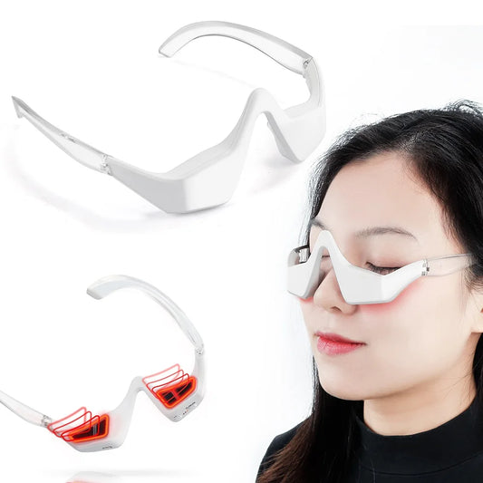 Woman wearing the 3D eye massager with red light therapy activated around her eyes